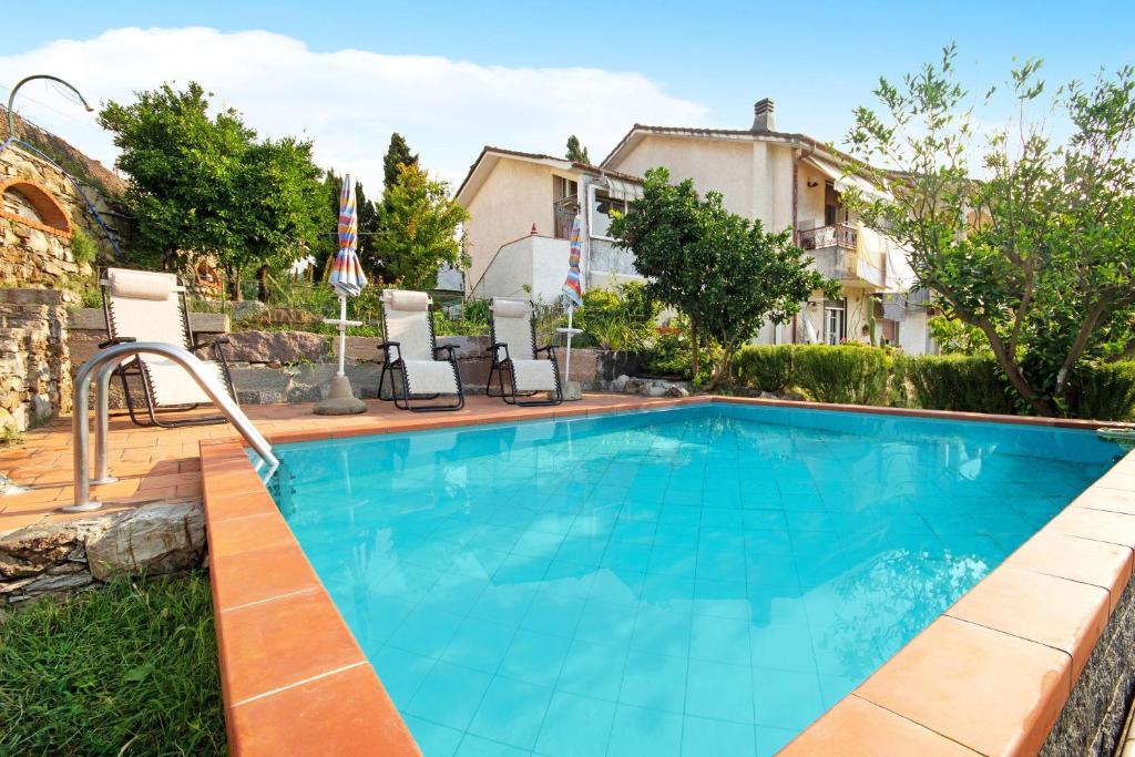 a swimming pool in the backyard of a house at Ca Olivella in Casarza Ligure
