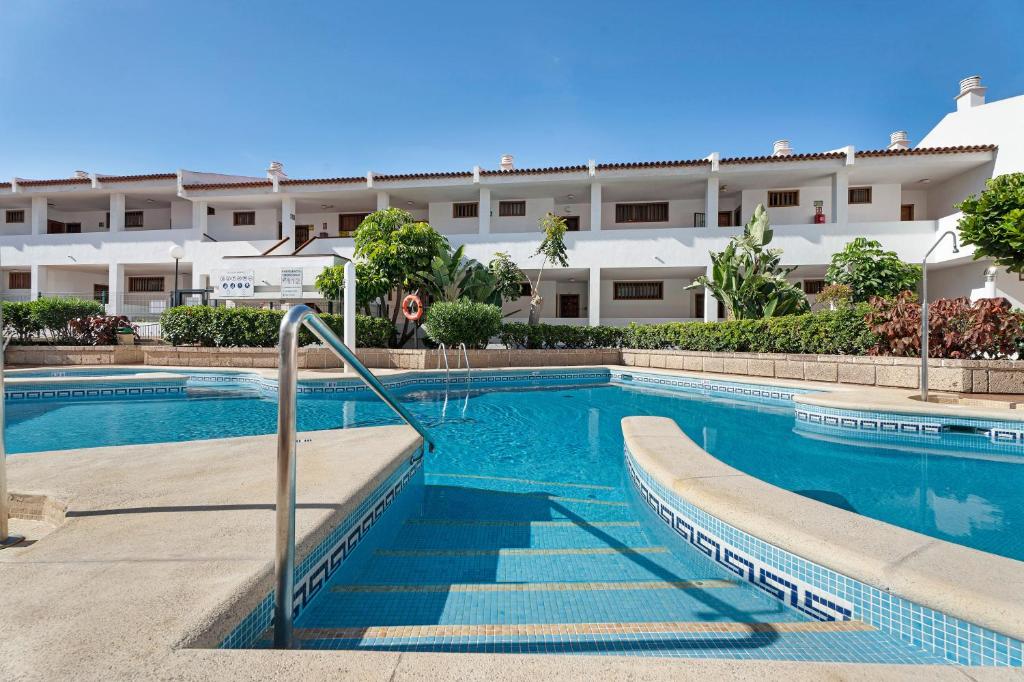 a swimming pool in front of a building at Ocean Park 311 in Adeje