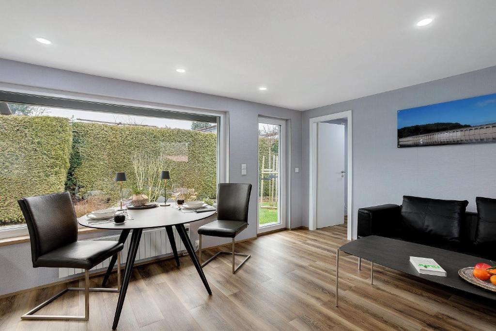 a living room with a table and chairs and a couch at Ferienhaus Adelon in Möhnesee