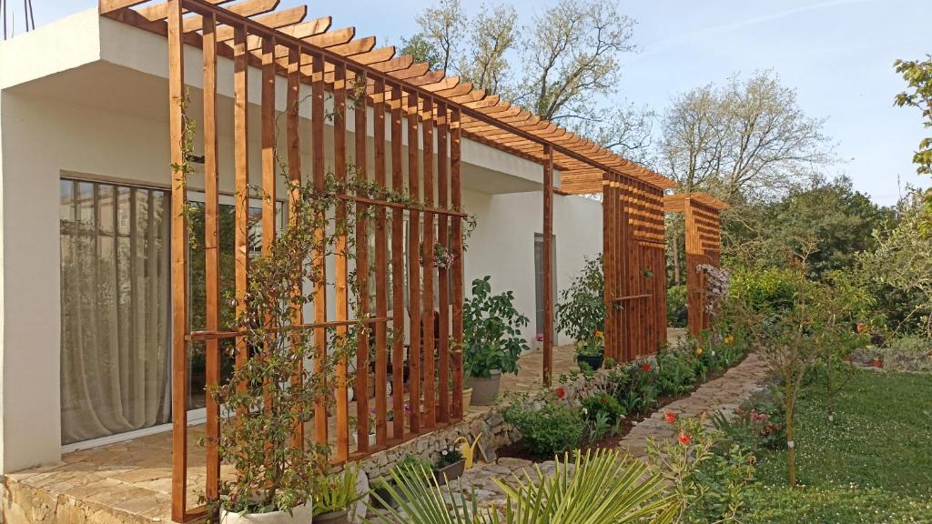 a garden with a wooden fence and some plants at RomaOlyaHouse in Budva
