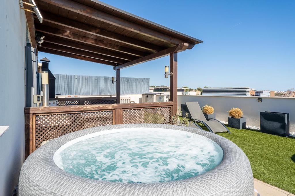 a hot tub on the balcony of a house at Sunset- Spa and Bbq in Calafell