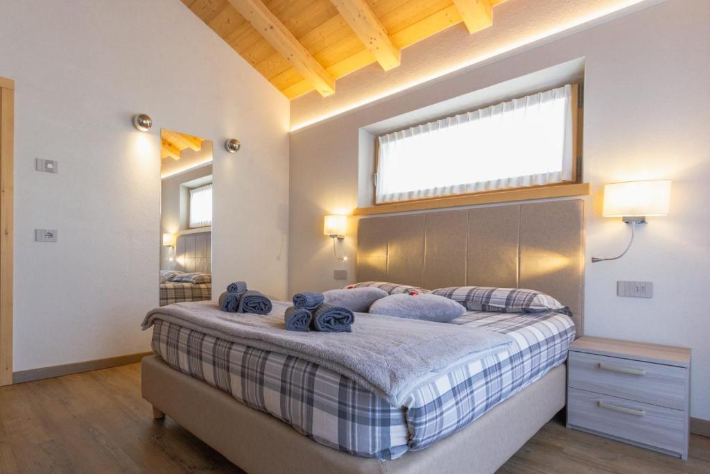a bedroom with a large bed with a window at Appartamento Sant'Antoni Fontana in Livigno