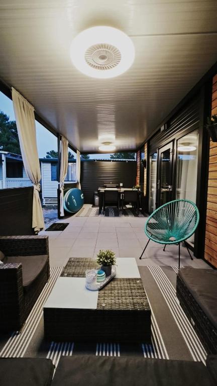 a living room with a table and a couch and a dining room at Mobile home Sunset, Privlaka in Privlaka