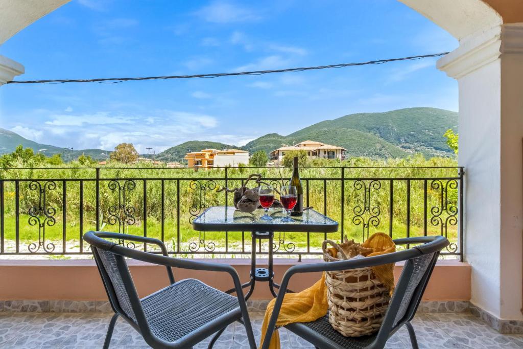a table and chairs on a balcony with a view at Studio Aias in Póndi