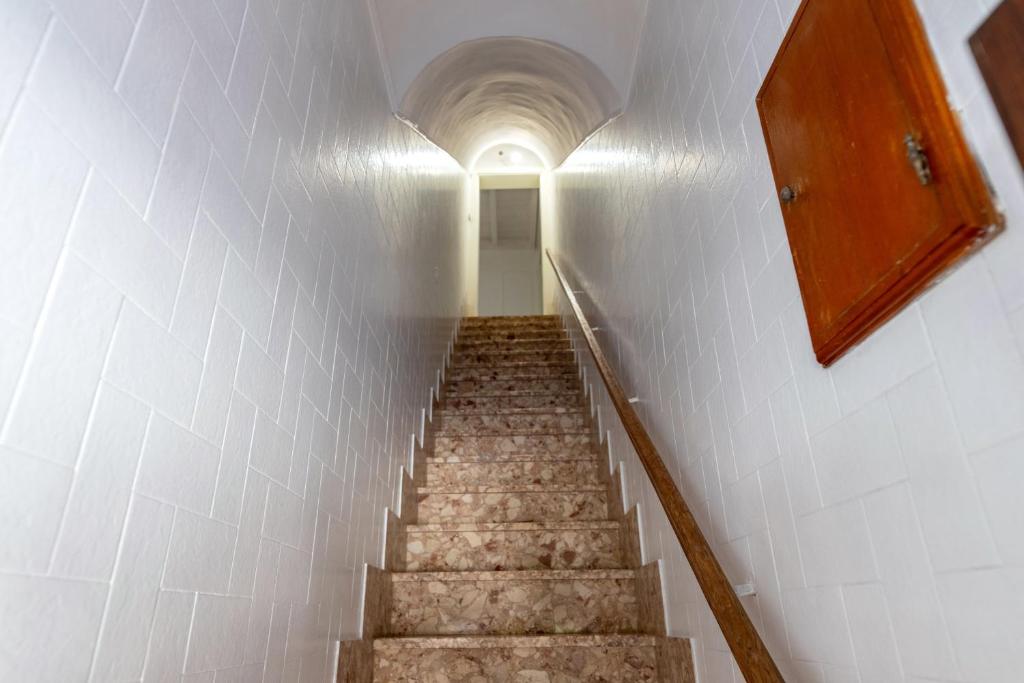 a staircase in a building with a white wall at Gma Home Primo Piano in Pulsano
