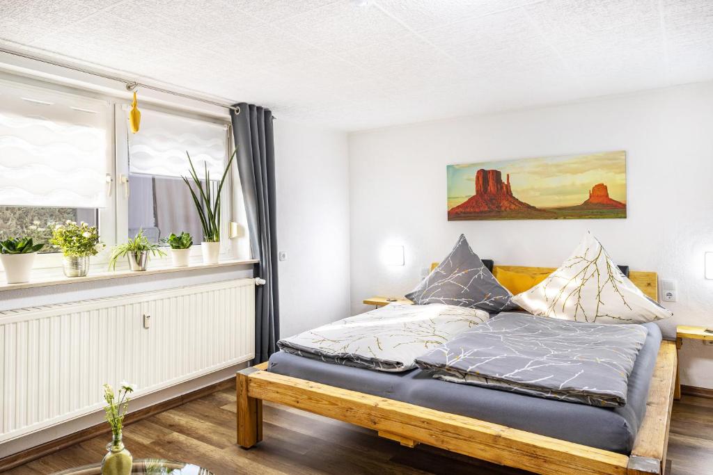 a bedroom with a bed and a window at Angie's Ferienapartment in Lichtenfels