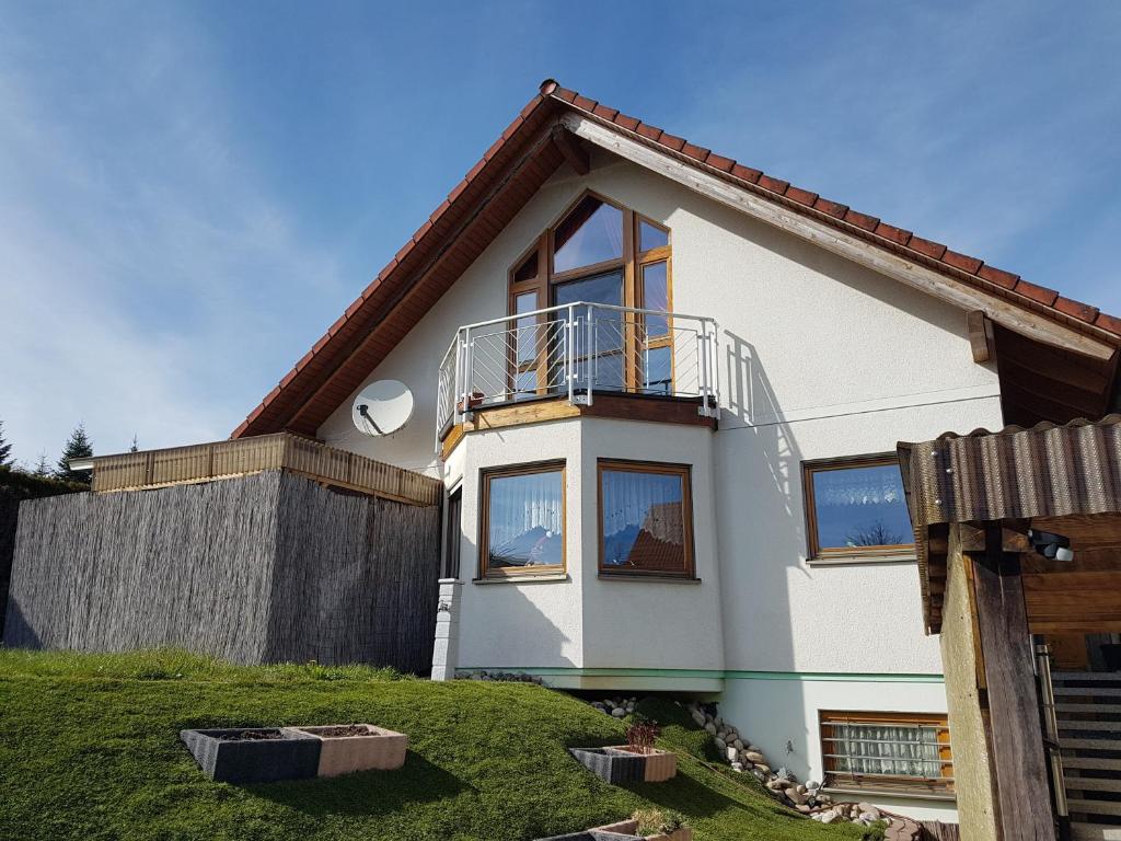 a white house with a balcony on top of it at Haus Herdi-Schön in Herdwangen-Schönach