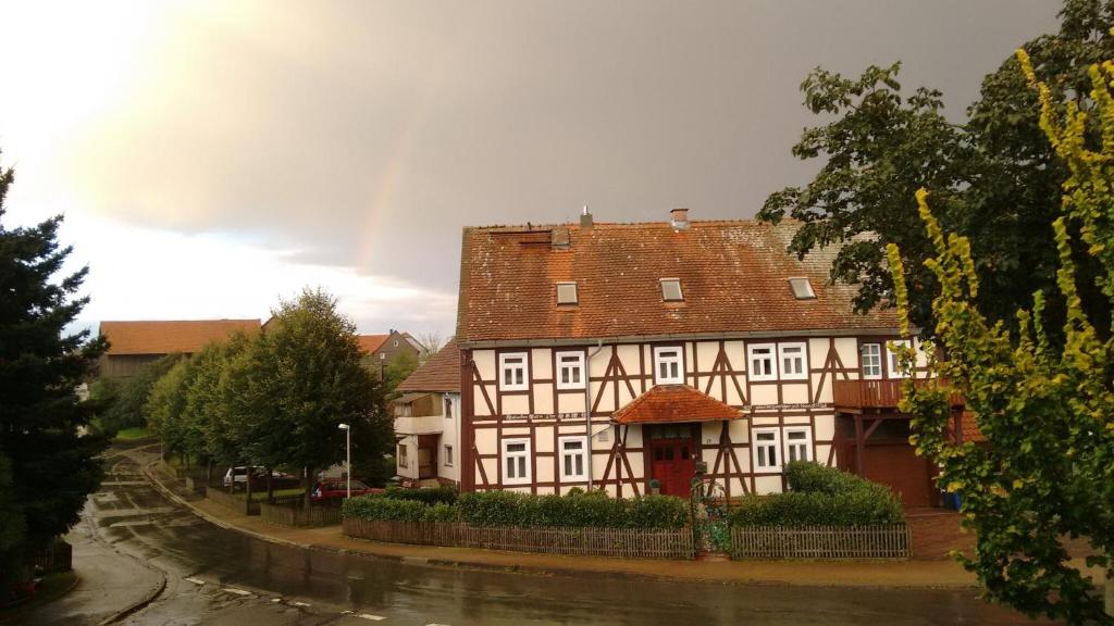 a large building with a red roof on a street at Alte Schule in Bad Wildungen