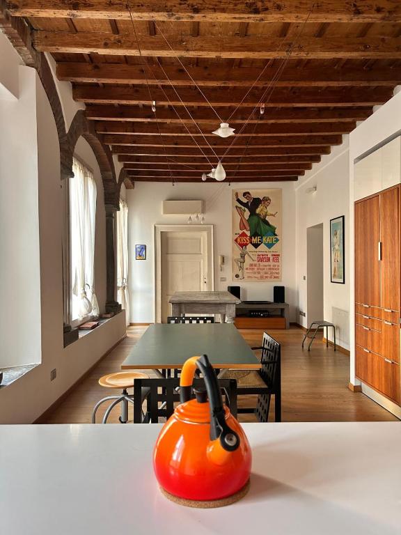 an orange kettle sitting on a table in a room at La Contrada - Suite Apartment in Sarnico