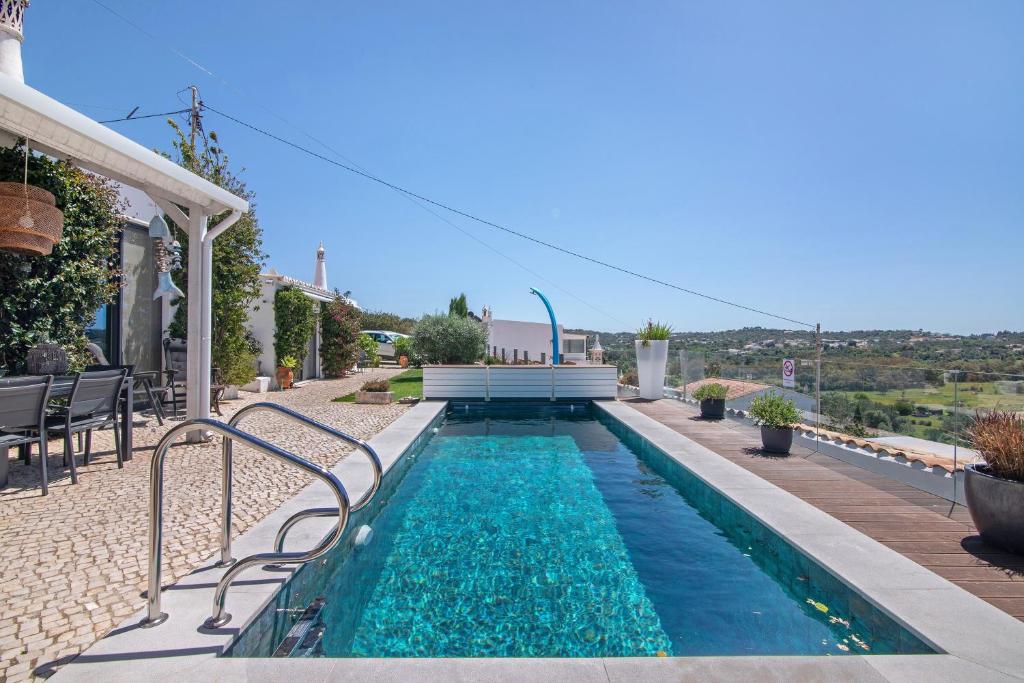 a swimming pool in the backyard of a house at Tiny House in São Brás de Alportel