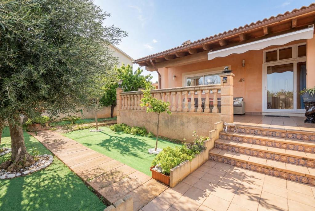 a home with a wooden fence and a yard at Cas Momio in Palma de Mallorca