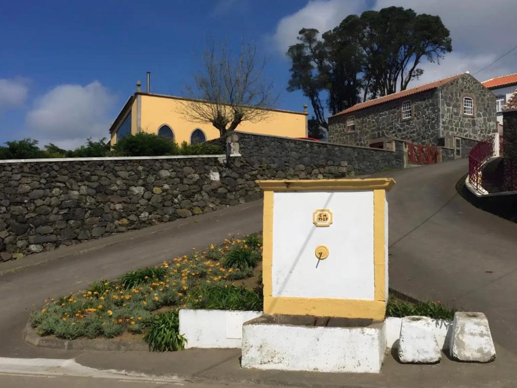 a white door sitting on the side of a road at Serreta Island Home in Serreta