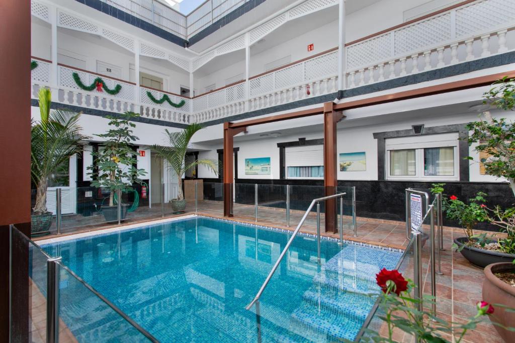 an indoor swimming pool in a building at Casa Paula - 22 in Arinaga