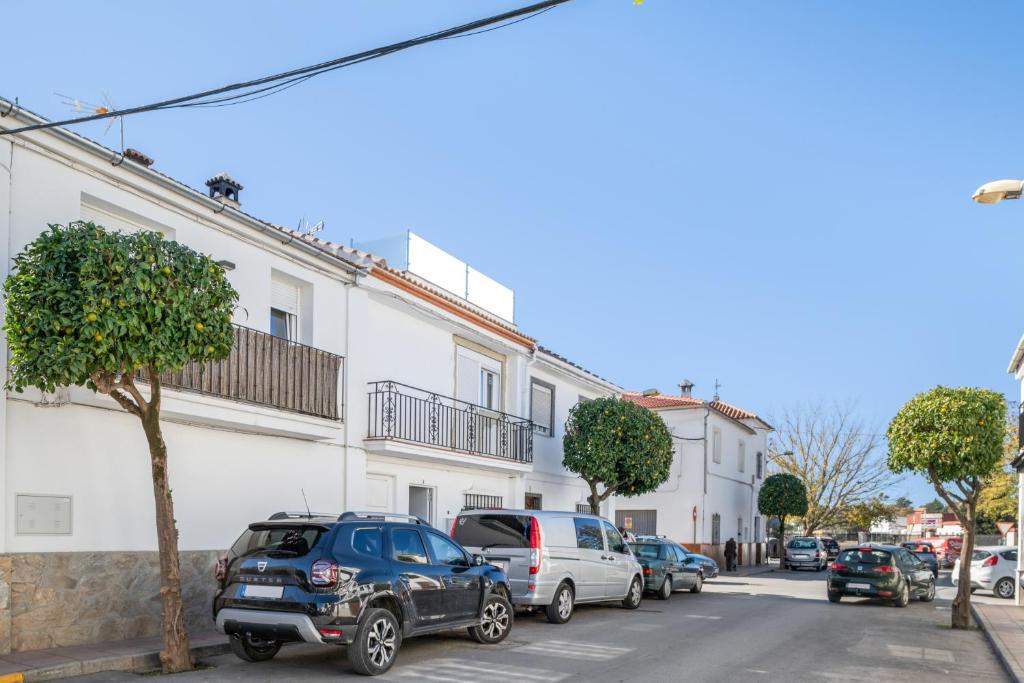 a street with cars parked on the street at Apartamentos Serranía in Ronda