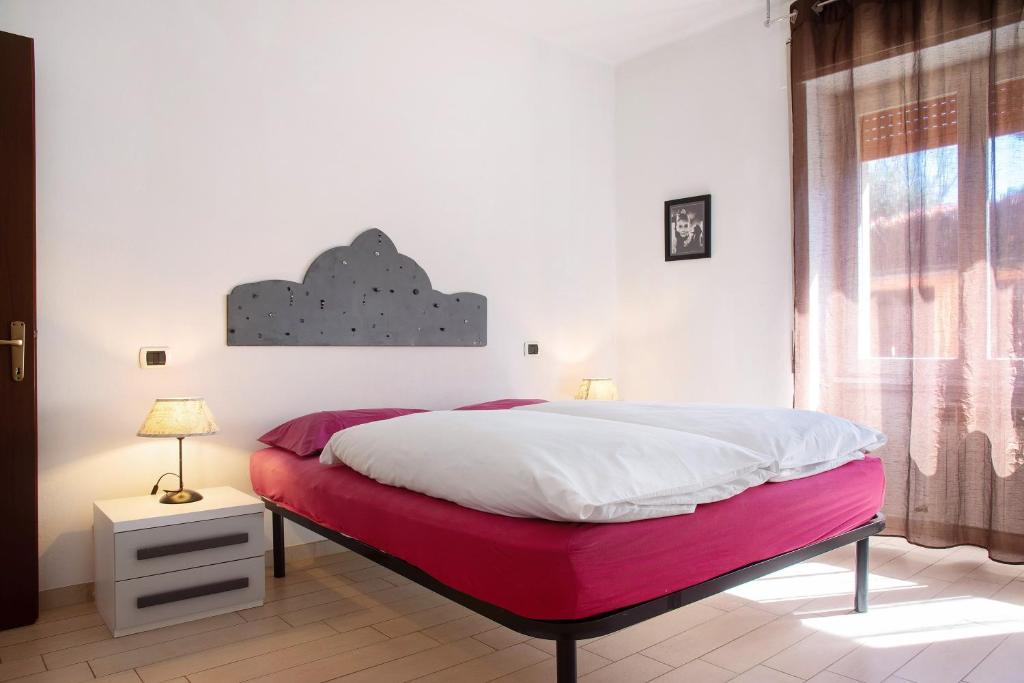 a bedroom with a large bed with a red blanket at Mariva in Germignaga