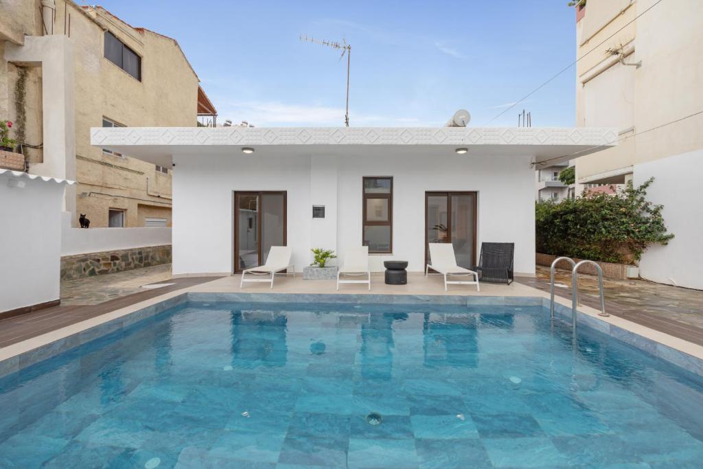 a pool in the backyard of a house at Luxsuites in Chania