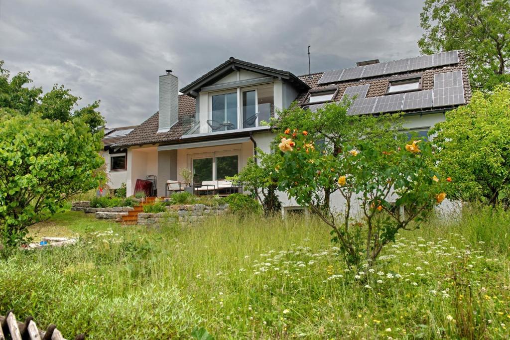 a house with solar panels on the roof at Aussichtsreich Am See in Uhldingen-Mühlhofen