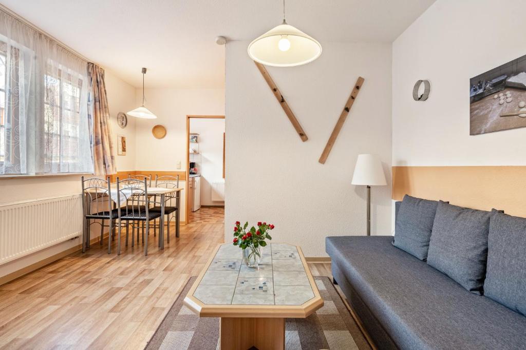 a living room with a couch and a table at Ferienwohnung Ufert in Meißen
