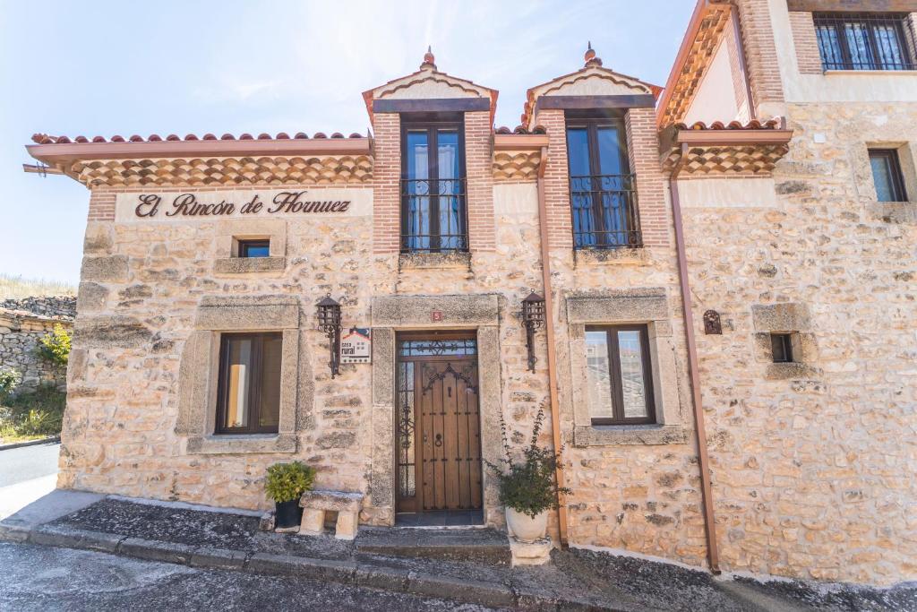 a stone building with a door in front of it at El Rincón de Hornuez in Moral