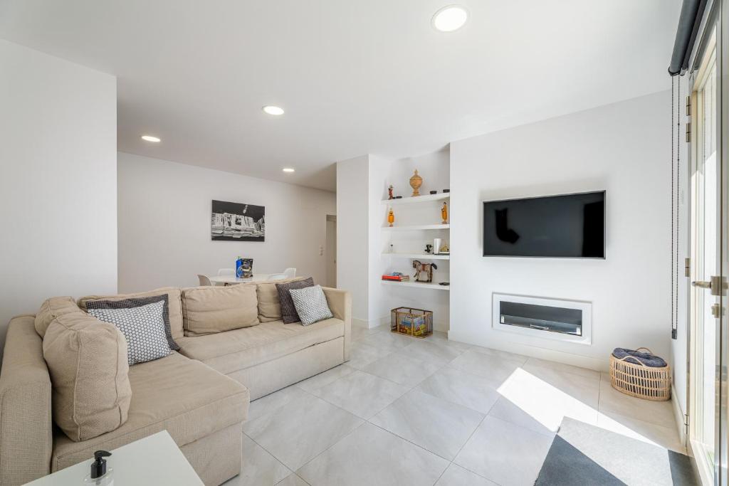 a living room with a couch and a tv at Bonanova 20 in Palma de Mallorca