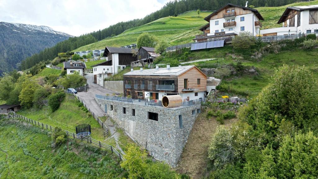 a group of houses on a hill with a building at Ansitz Röfen in Burgusio