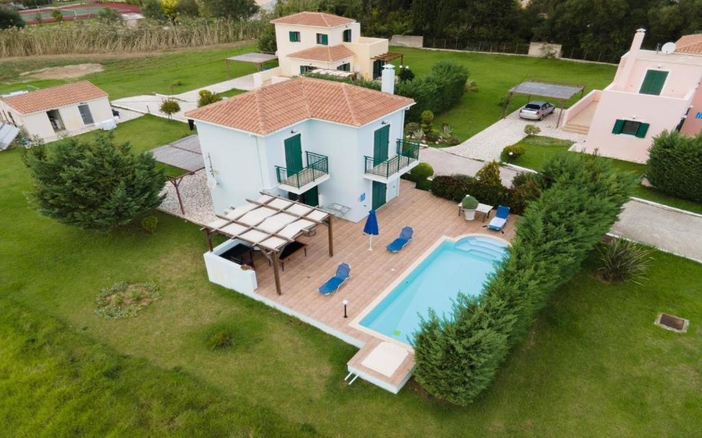 an aerial view of a house with a swimming pool at Sami Beach Villas Nefeli in Karavomylos