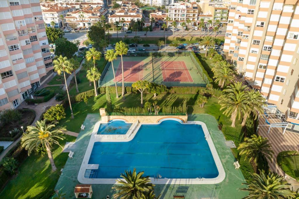 an overhead view of a pool and tennis court in a city at Estudio Bloque 84 in Torrox