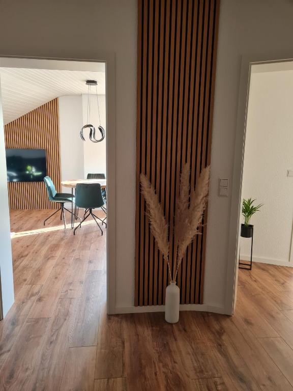 a room with a vase with a plant in it at Dasensteinblick in Kappelrodeck