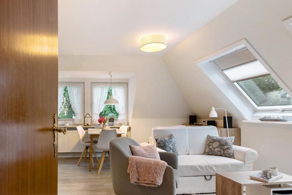 a living room with a couch and a table at Appartement Skagen in Glücksburg