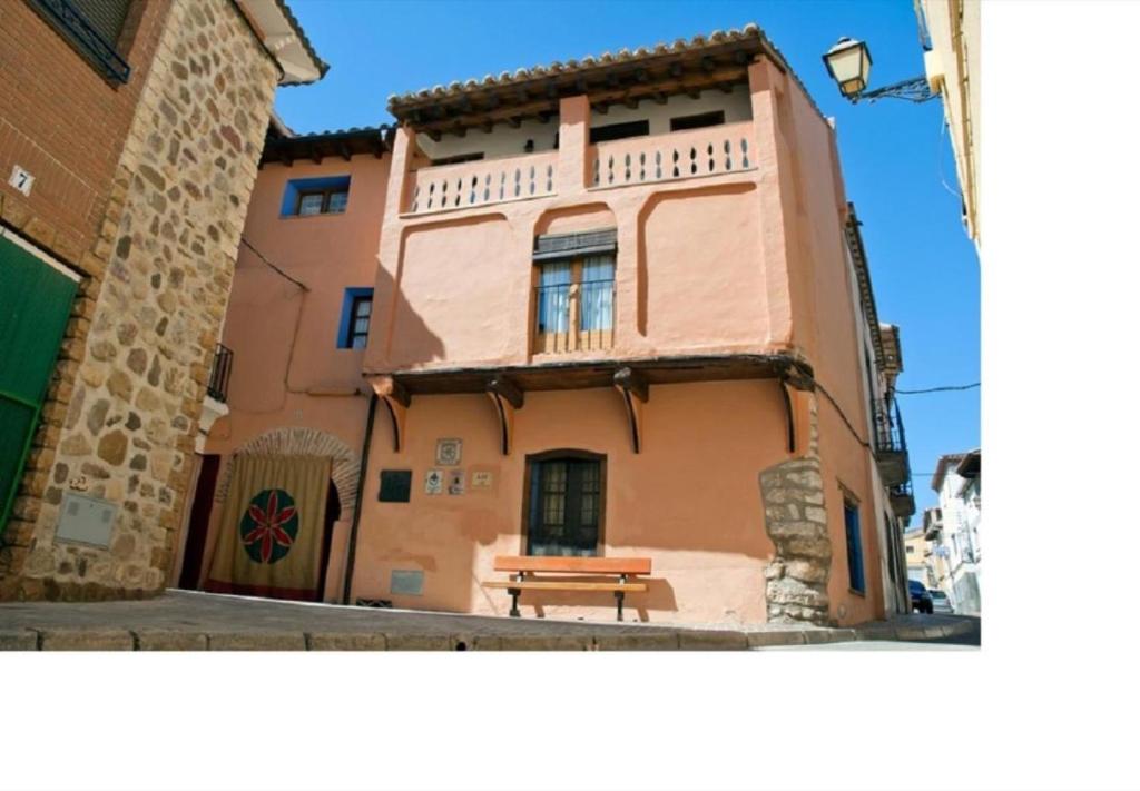 a building with a bench in front of it at Casa Jara in Azuara