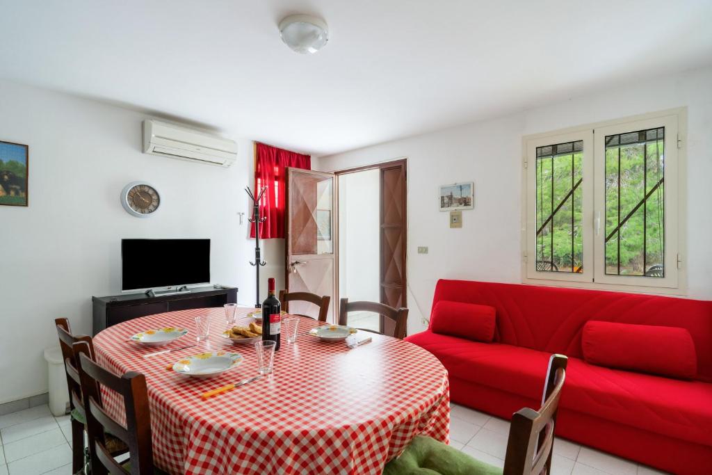 a living room with a table and a red couch at La Castellana in Gallipoli