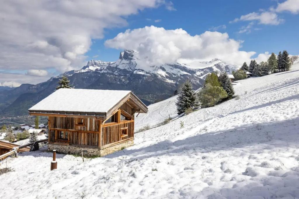 a wooden cabin on a snow covered mountain at Mazot de Warens in Combloux