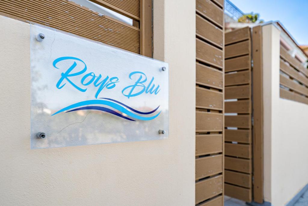 a sign on a building that reads hope bin at Roys Blu in Kavos
