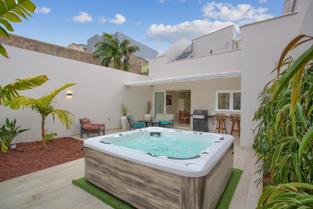 a hot tub in the backyard of a house at Mojo Surf Yoga House in La Orotava