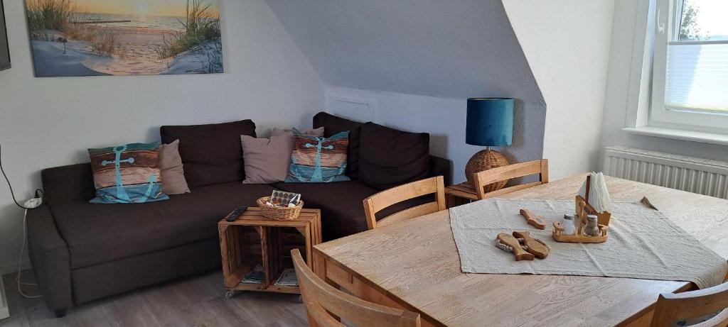 a living room with a couch and a table at Fewo Sandbank in Pellworm