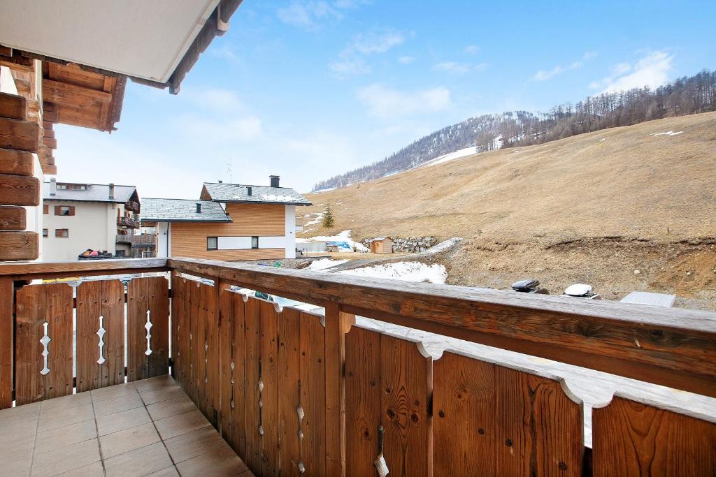 a balcony of a house with a wooden fence at Chalet Anna Cigambola in Livigno