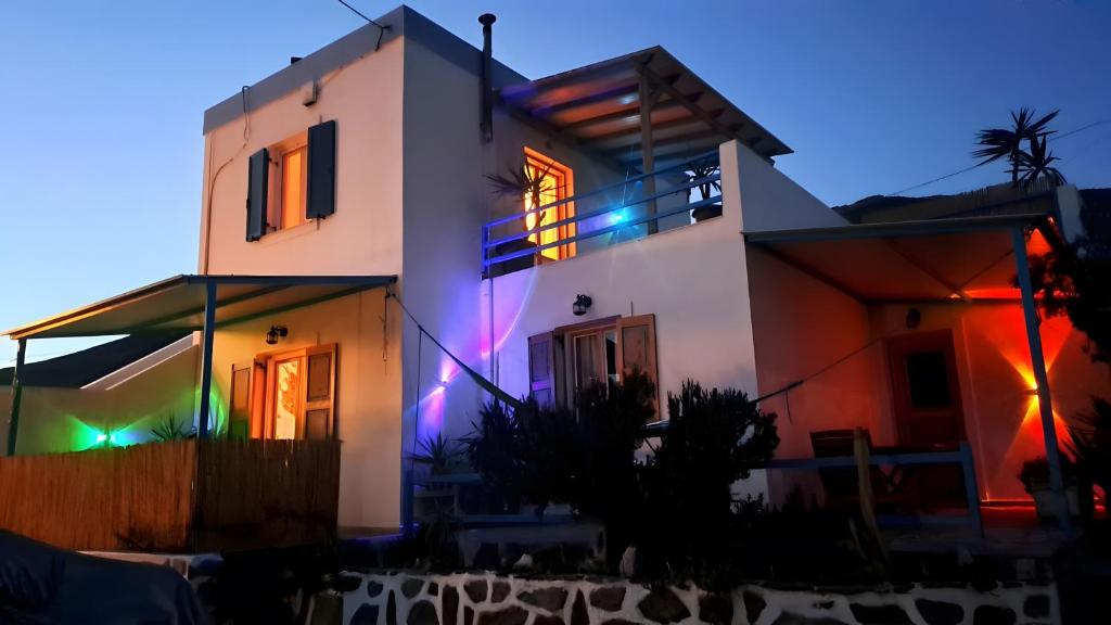 a white house with colorful lights on it at Syros Mandala Studio in Ano Syros