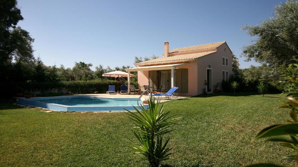 a house with a swimming pool in a yard at Villa Fotini Lefkada in Lefkada