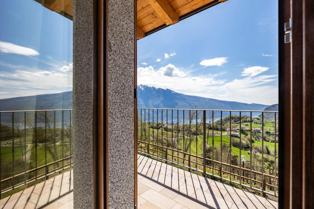 a room with a view of the mountains from a balcony at Agriturismo Bocca Nevese Pino in Tremosine Sul Garda