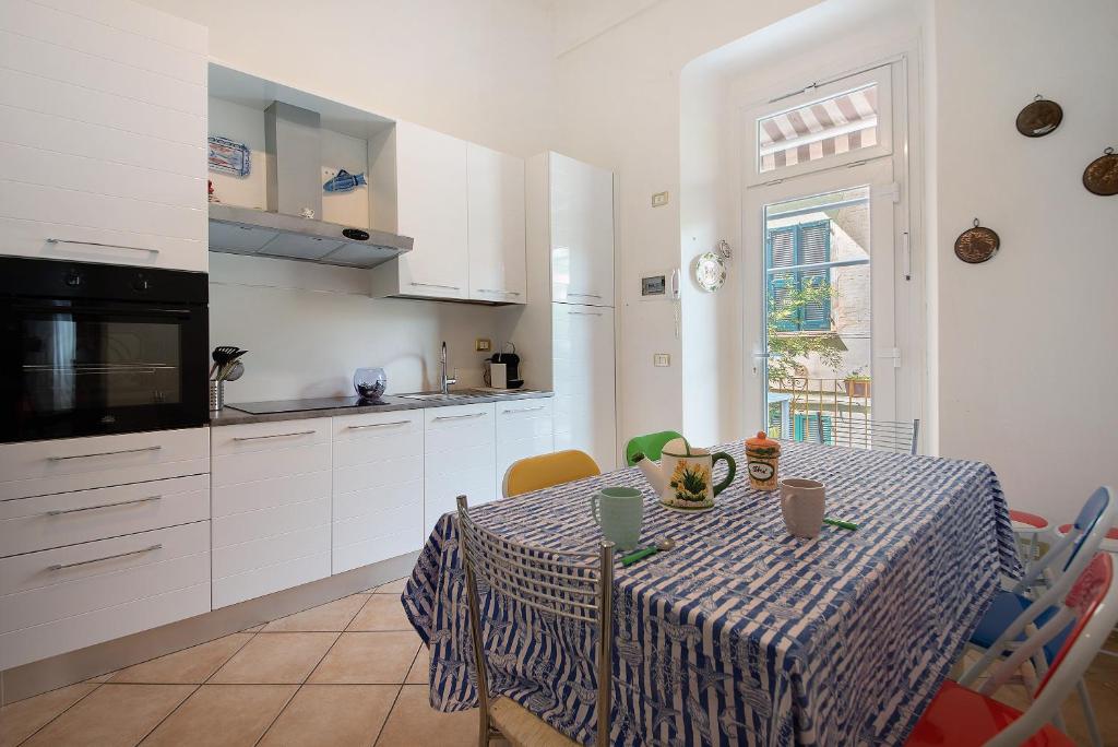a kitchen with a table with a table cloth on it at Levanto A 50 Metri dal Mare in Levanto