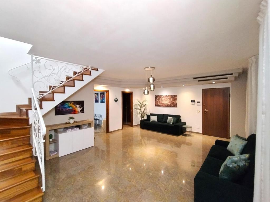 a living room with a staircase and a couch at Royal Residence Abano Terme in Abano Terme