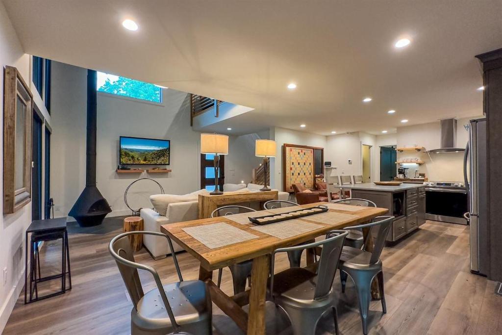 a living room with a table and a kitchen at Hemlock Cottage · Hemlock Cottage in Pisgah Forest - Pet Friendl in Brevard