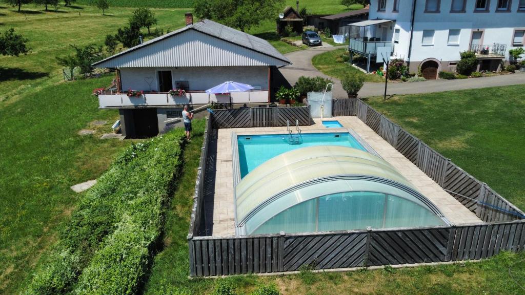 an overhead view of a swimming pool and a house at Fewo Siglinde Schneider in Freiamt