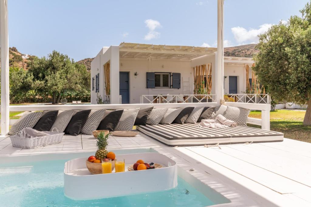 a bowl of fruit sitting on the edge of a pool at Ow Andros Suite 5,Private Whirlpool in Andros