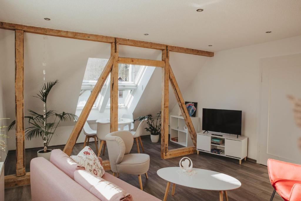 a living room with a couch and a tv at Ferienwohnung Wunderbar in Bad Wildbad