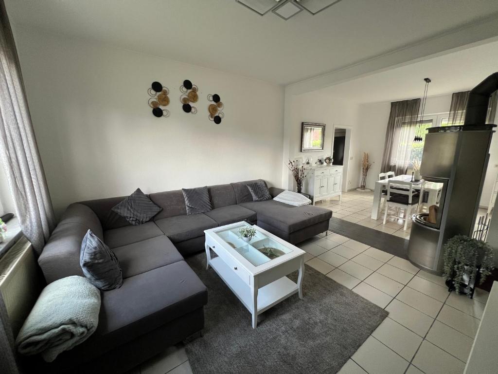 a living room with a couch and a table at Ferienhaus Almir in Haselünne