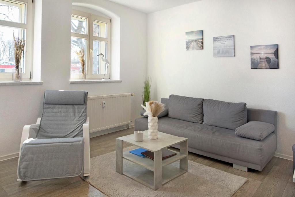 a living room with a couch and a chair and a table at Ferienwohnung Havelvorland in Havelberg