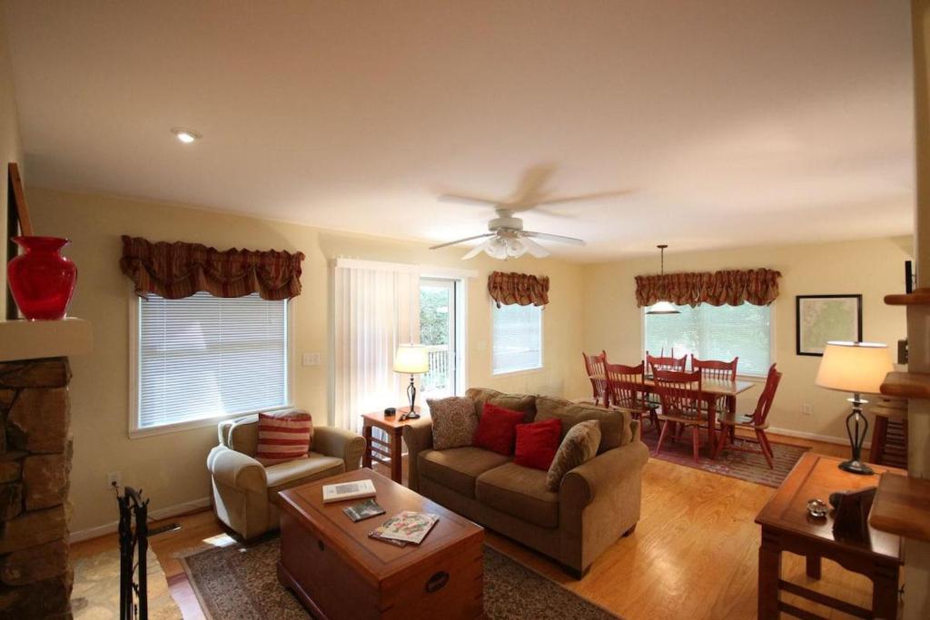 a living room with a couch and a ceiling fan at White Squirrel`s Nest · White Squirrel`s Nest in Sherwood Forest in Rosman