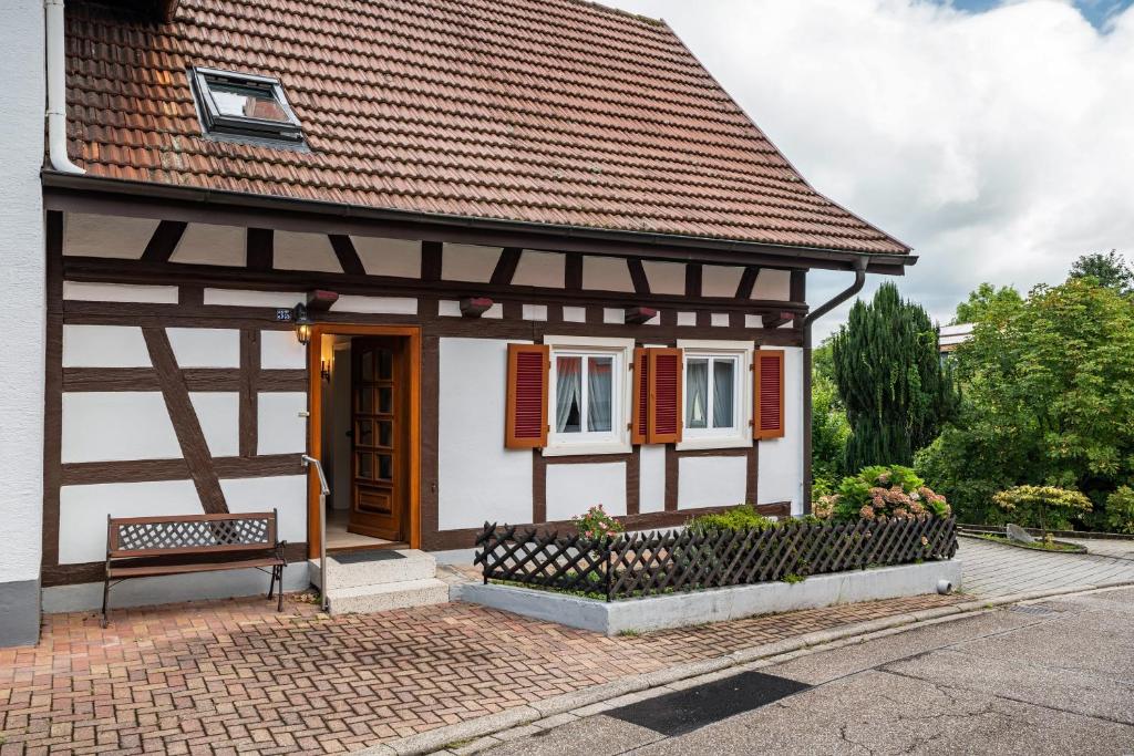 a small house with a bench in front of it at Ferienhaus Albert in Bühl