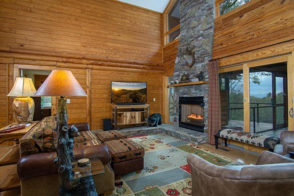a living room with a couch and a fireplace at Blissful Bears Mountain · Blissful Bear Cabin, Long Range View 2 in Brevard